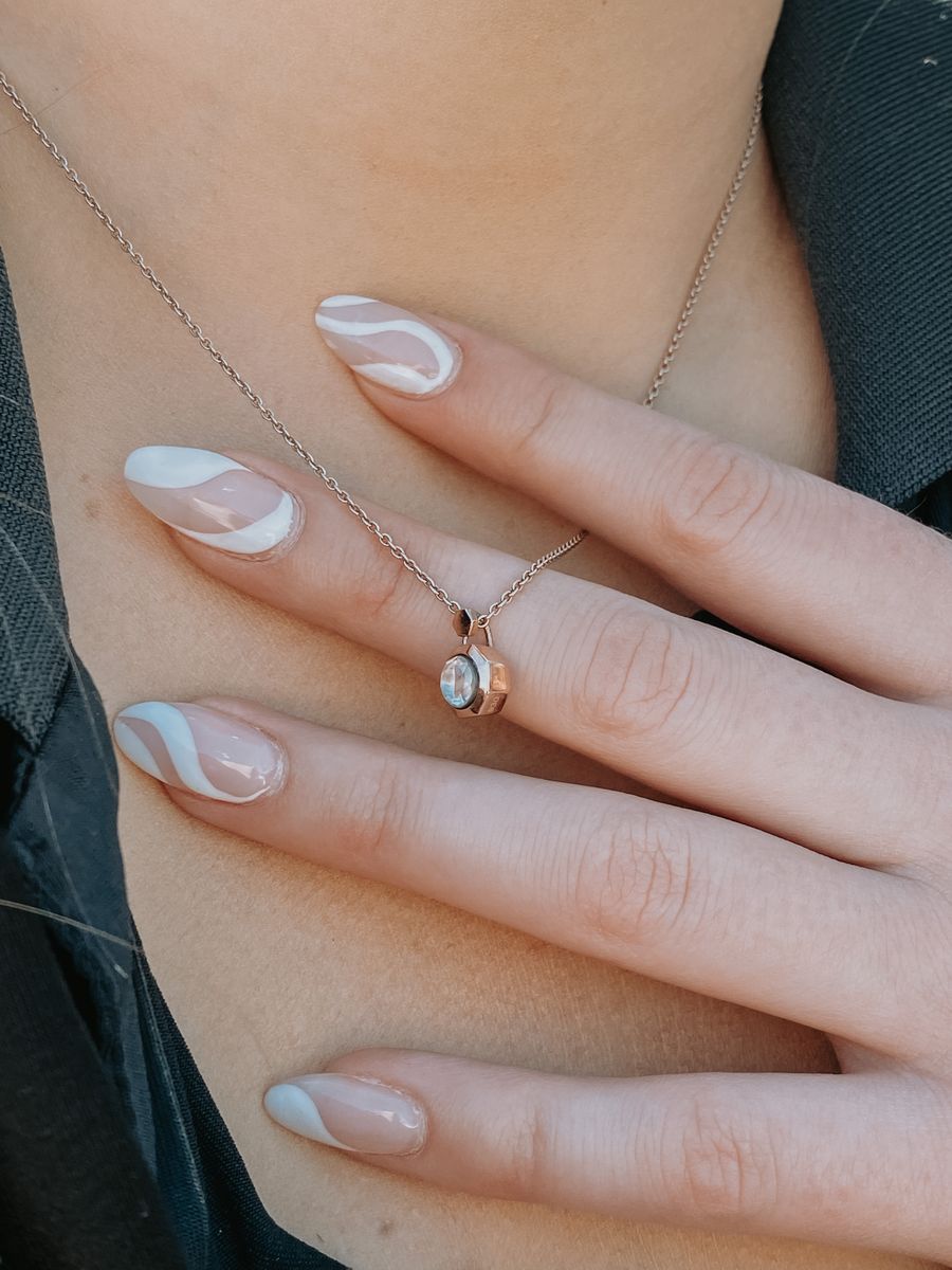 White swirl nail art on almond nails